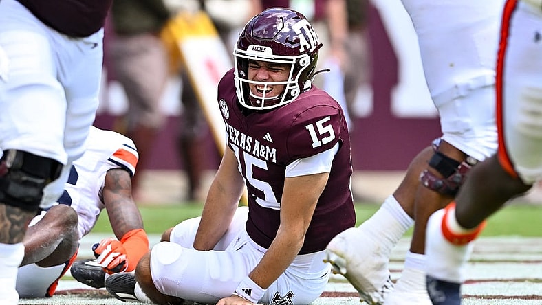 Sep 23, 2023; College Station, Texas, USA; Texas A&M Aggies quarterback Conner Weigman (15) reacts after getting hit during the second quarter against the Auburn Tigers at Kyle Field. Mandatory Credit: Maria Lysaker-USA TODAY Sports