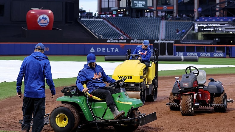 Sep 26, 2023; New York City, New York, USA; Members of the grounds crew attempt to dry the field during a delayed start before a game between the New York Mets and Miami Marlins at Citi Field. Mandatory Credit: Brad Penner-USA TODAY Sports