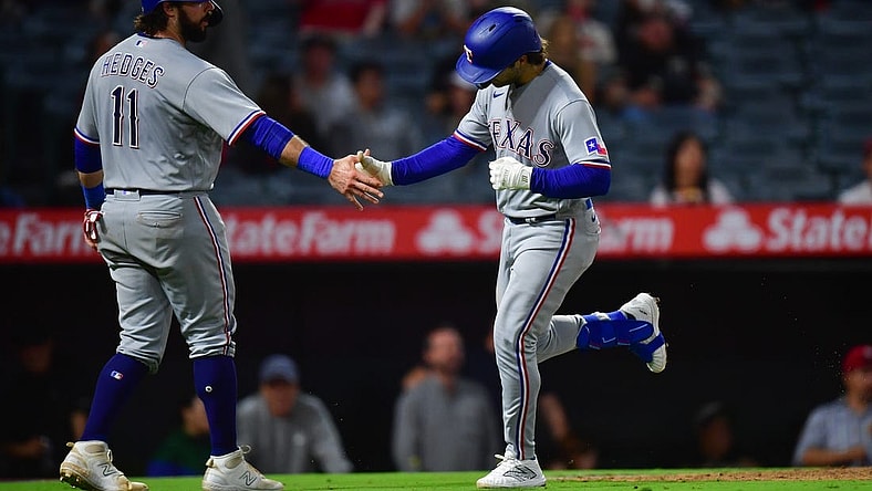 Sep 26, 2023; Anaheim, California, USA; Texas Rangers shortstop Josh Smith (47) is greeted by catcher Austin Hedges (11) after hitting a two run home run against the Los Angeles Angels during the ninth inning at Angel Stadium. Mandatory Credit: Gary A. Vasquez-USA TODAY Sports