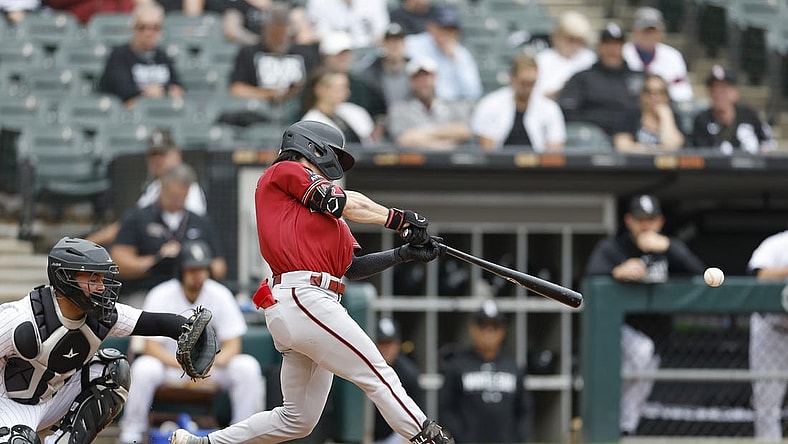 Sep 27, 2023; Chicago, Illinois, USA; Arizona Diamondbacks left fielder Corbin Carroll (7) hits a two-run double against the Chicago White Sox during the third inning at Guaranteed Rate Field. Mandatory Credit: Kamil Krzaczynski-USA TODAY Sports
