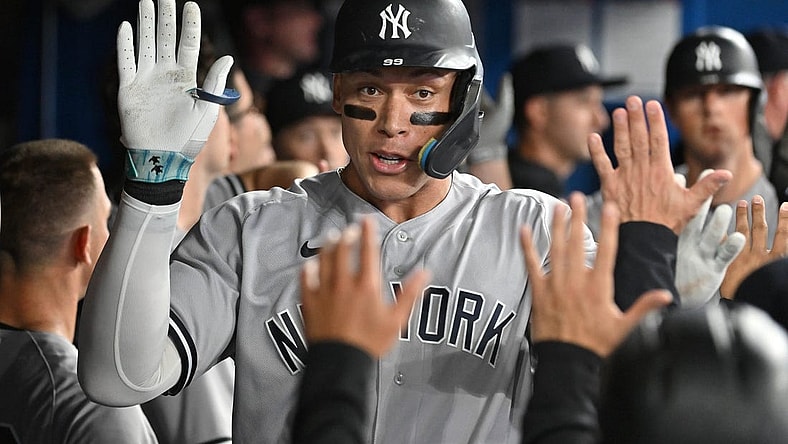Sep 27, 2023; Toronto, Ontario, CAN; New York Yankees right fielder Aaron Judge (99) celebrates in the dugout with team mates after hitting a two run home run against the Toronto Blue Jays in the fourth inning at Rogers Centre. Mandatory Credit: Dan Hamilton-USA TODAY Sports