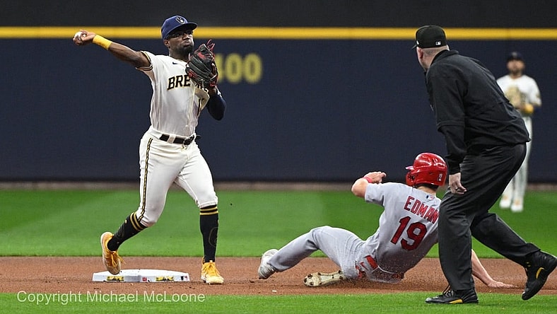 Sep 27, 2023; Milwaukee, Wisconsin, USA; Milwaukee Brewers second baseman Andruw Monasterio (14) forces out St. Louis Cardinals shortstop Tommy Edman (19) and turns the double play in the first inning at American Family Field. Mandatory Credit: Michael McLoone-USA TODAY Sports