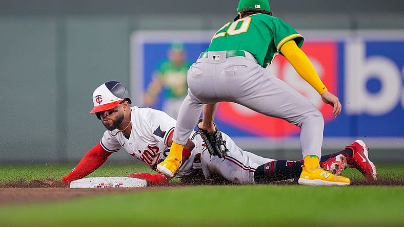 Sep 27, 2023; Minneapolis, Minnesota, USA; Minnesota Twins center fielder Willi Castro (50) steals second base against the Oakland Athletics second baseman Zack Gelof (20) in the second inning at Target Field. Mandatory Credit: Brad Rempel-USA TODAY Sports