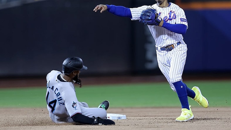 Sep 28, 2023; New York City, New York, USA; New York Mets shortstop Francisco Lindor (12) steps on second to force out Miami Marlins right fielder Bryan De La Cruz (14) and throws to first to attempt a double play on a ball hit by Marlins shortstop Garrett Hampson (not pictured) during the second inning at Citi Field. Hampson was safe at first on the play. Mandatory Credit: Brad Penner-USA TODAY Sports