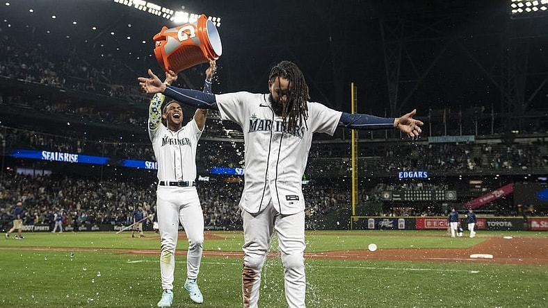 Sep 28, 2023; Seattle, Washington, USA; Seattle Mariners centerfielder Julio Rodriguez (44) dumps a bucket of water on shortstop J.P. Crawford (3) while celebrating after a game against the Texas Rangers at T-Mobile Park. Mandatory Credit: Stephen Brashear-USA TODAY Sports