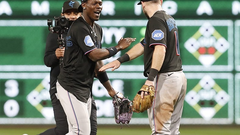 Sep 29, 2023; Pittsburgh, Pennsylvania, USA;  Miami Marlins center fielder Jazz Chisholm Jr. (2) and shortstop  Garrett Hampson (1) celebrate after defeating the Pittsburgh Pirates at PNC Park. Miami won 4-3. Mandatory Credit: Charles LeClaire-USA TODAY Sports