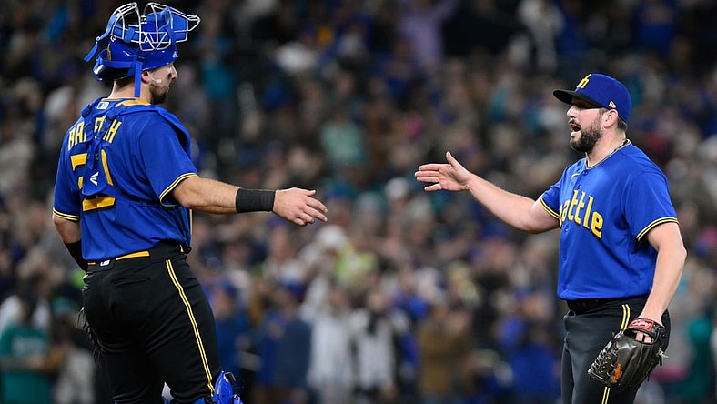 Sep 29, 2023; Seattle, Washington, USA; Seattle Mariners catcher Cal Raleigh (29) and relief pitcher Dominic Leone (54) celebrate defeating the Texas Rangers at T-Mobile Park. Mandatory Credit: Steven Bisig-USA TODAY Sports
