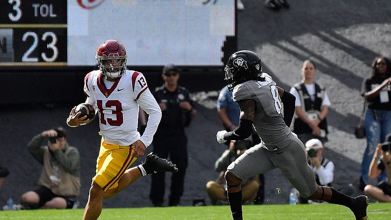 Sep 30, 2023; Boulder, Colorado, USA; USC Trojans quarterback Caleb Williams (13) scrambles for a few yards as he gets chased by Colorado Buffaloes safety Jahquez Robinson (8) during the first quarter at Folsom Field. Mandatory Credit: John Leyba-USA TODAY Sports
