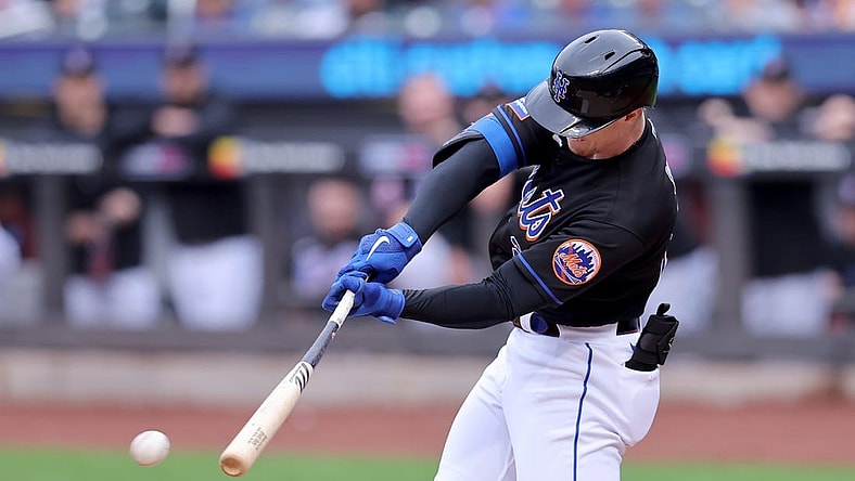 Sep 30, 2023; New York City, New York, USA; New York Mets designated hitter Brett Baty (22) hits an RBI single against the Philadelphia Phillies during the first inning at Citi Field. Mandatory Credit: Brad Penner-USA TODAY Sports