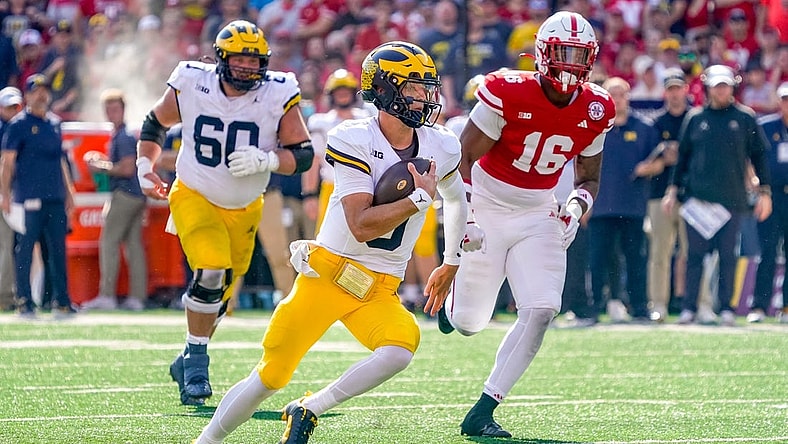 Sep 30, 2023; Lincoln, Nebraska, USA; Michigan Wolverines quarterback J.J. McCarthy (9) runs for a touchdown against Nebraska Cornhuskers defensive lineman Elijah Jeudy (16) during the second quarter at Memorial Stadium. Mandatory Credit: Dylan Widger-USA TODAY Sports