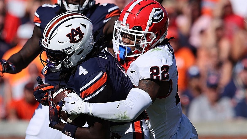 Sep 30, 2023; Auburn, Alabama, USA; Georgia Bulldogs defensive back Javon Bullard (22) tackles Auburn Tigers wide receiver Camden Brown (4) during the second quarter at Jordan-Hare Stadium. Mandatory Credit: John Reed-USA TODAY Sports