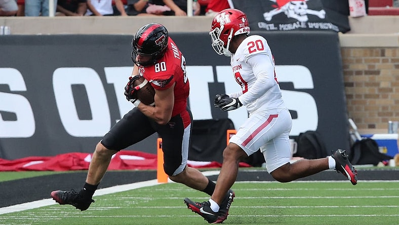 Sep 30, 2023; Lubbock, Texas, USA; Texas Tech Red Raiders tight end Mason Tharp (80) rushes against Houston Cougars defensive safety Antonio Brooks (20) in the first half at Jones AT&T Stadium and Cody Campbell Field. Mandatory Credit: Michael C. Johnson-USA TODAY Sports