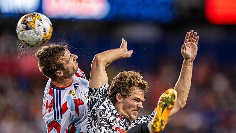 Sep 30, 2023; Harrison, New Jersey, USA; Chicago Fire defender Wyatt Omsberg (left) jumps to head the ball against New York Red Bulls forward Tom Barlow (right) during the first half at Red Bull Arena. Mandatory Credit: Mark Smith-USA TODAY Sports