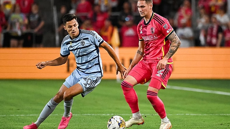 Sep 30, 2023; St. Louis, Missouri, USA; Sporting Kansas City forward D  niel Sall  i (20) and St. Louis City defender Jake Nerwinski (2) battle for the ball during the first half at CITYPARK. Mandatory Credit: Joe Puetz-USA TODAY Sports