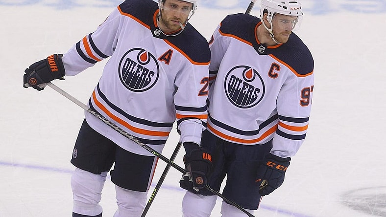 Dec 31, 2021; Newark, New Jersey, USA; Edmonton Oilers center Leon Draisaitl (29) and Edmonton Oilers center Connor McDavid (97) talk during overtime of their game against the New Jersey Devils at Prudential Center. Mandatory Credit: Ed Mulholland-USA TODAY Sports