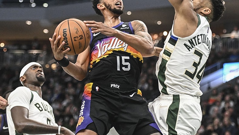 Mar 6, 2022; Milwaukee, Wisconsin, USA; Phoenix Suns guard Cameron Payne (15) looks for a shot against Milwaukee Bucks forward Giannis Antetokounmpo (34) in the second quarter at Fiserv Forum. Mandatory Credit: Benny Sieu-USA TODAY Sports