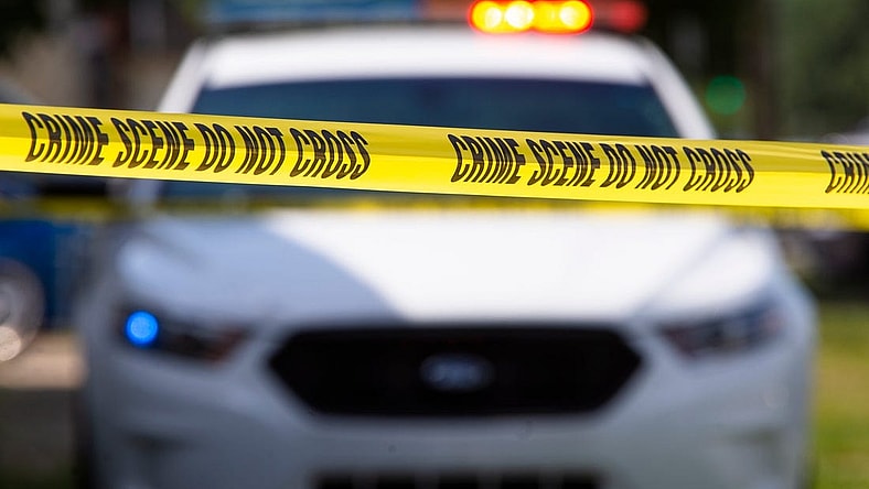 Crime scene tape near a squad car.

Police File Photo