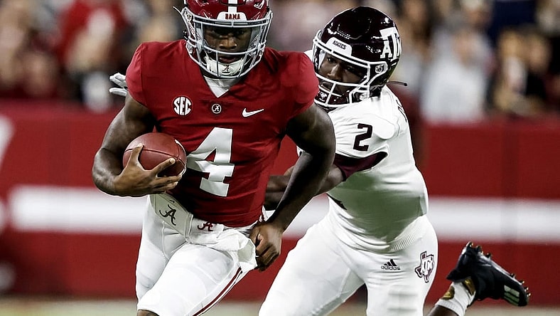 Oct 8, 2022; Tuscaloosa, Alabama, USA;  Alabama Crimson Tide quarterback Jalen Milroe (4) scrambles for yardage against Texas A&M Aggies defensive back Denver Harris (2) during the first half at Bryant-Denny Stadium. Mandatory Credit: Butch Dill-USA TODAY Sports