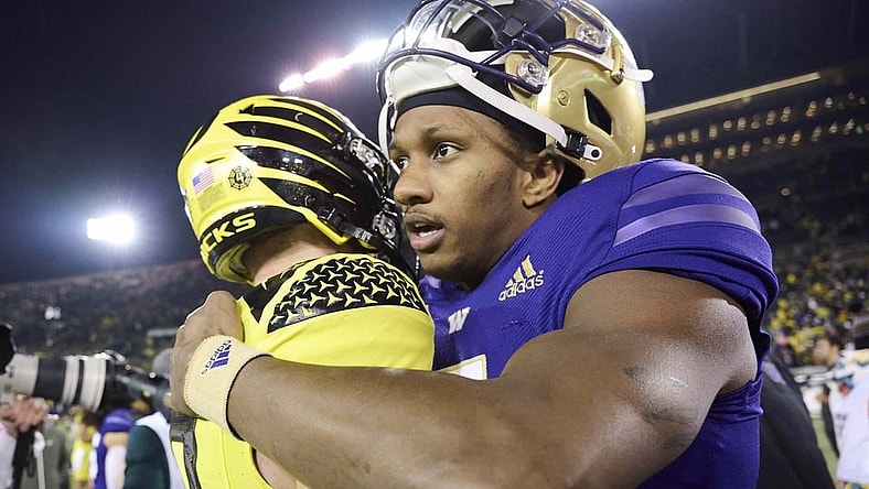 Nov 12, 2022; Eugene, Oregon, USA; Washington Huskies quarterback Michael Penix Jr. (9) embraces Oregon Ducks quarterback Bo Nix (10) after a game at Autzen Stadium. The Huskies won the game 37-34.  Mandatory Credit: Troy Wayrynen-USA TODAY Sports