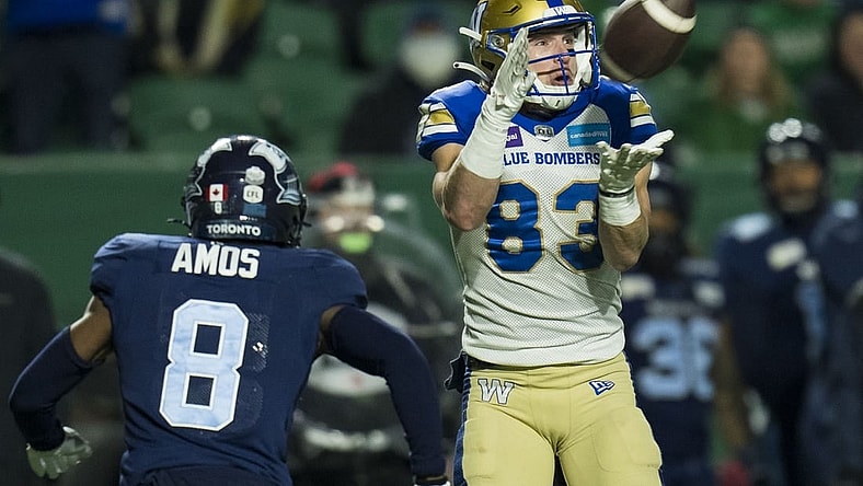 Nov 20, 2022; Regina, Saskatchewan, CAN; Toronto Argonauts defensive back DaShaun Amos (8) looks on as Winnipeg Blue Bombers receiver Dalton Schoen (83) makes a catch during the first half at Mosaic Stadium. Mandatory Credit: Bob Frid-USA TODAY Sports