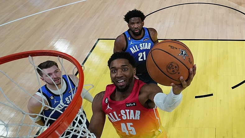 Feb 19, 2023; Salt Lake City, UT, USA; Team Giannis guard Donovan Mitchell (45) goes up for a shot against Team LeBron forward Luka Doncic (77) and center Joel Embiid (21) in the 2023 NBA All-Star Game at Vivint Arena. Mandatory Credit: Kyle Terada-USA TODAY Sports