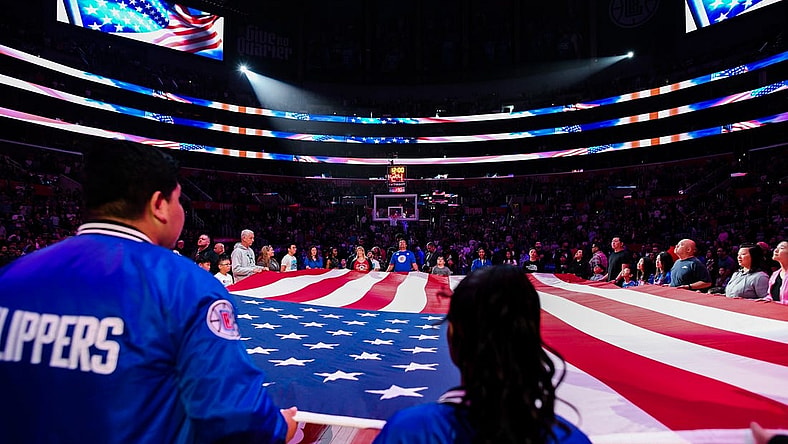 Apr 8, 2023; Los Angeles, California, USA; LA Clippers fans hold the American flag during a pre-game ceremony against the Portland Trail Blazers at Crypto.com Arena. Mandatory Credit: Jonathan Hui-USA TODAY Sports