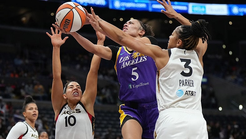 May 25, 2023; Los Angeles, California, USA; LA Sparks guard Dearica Hamby (5) shoots the ball against Las Vegas Aces forward Candace Parker (3) and guard Kelsey Plum (10) during the first half at Crypto.com Arena. Mandatory Credit: Kirby Lee-USA TODAY Sports