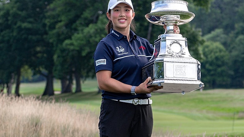 Jun 25, 2023; Springfield, New Jersey, USA; Ruoning Yin raises the championship trophy after winning the KPMG Women's PGA Championship golf tournament. Mandatory Credit: John Jones-USA TODAY Sports