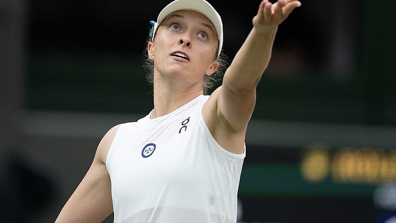 Jul 11, 2023; London, United Kingdom; Iga Swiatek (POL) tosses the ball to serve during her match against Elina Svitolina (UKR) on day nine of Wimbledon at the All England Lawn Tennis and Croquet Club.  Mandatory Credit: Susan Mullane-USA TODAY Sports