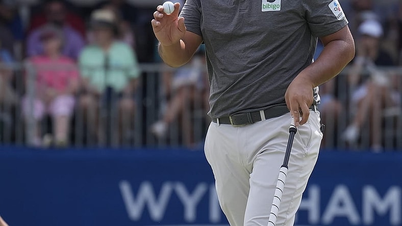 Aug 6, 2023; Greensboro, North Carolina, USA; Byeong Hun An shows the ball after a birdie on the 9th green during the final round of the Wyndham Championship golf tournament. Mandatory Credit: David Yeazell-USA TODAY Sports