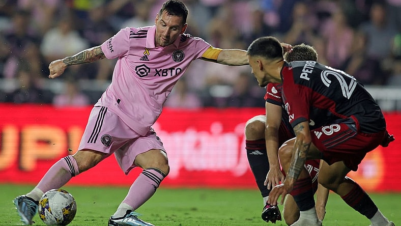 Sep 20, 2023; Fort Lauderdale, Florida, USA; Inter Miami forward Lionel Messi (10) kicks the ball past Toronto FC during the first half at DRV PNK Stadium. Mandatory Credit: Sam Navarro-USA TODAY Sports