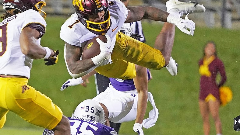 Sep 23, 2023; Evanston, Illinois, USA; Minnesota Golden Gophers running back Darius Taylor (1) leaps over Northwestern Wildcats linebacker Kenny Soares Jr. (35) during the second half at Ryan Field. Mandatory Credit: David Banks-USA TODAY Sports