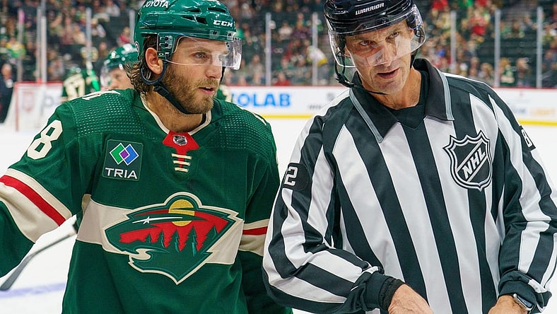 Sep 28, 2023; Saint Paul, Minnesota, USA; Minnesota Wild right wing Ryan Hartman (38) and referee Chris Lee (82) chat during a break in action against the Colorado Avalanche in the third period at Xcel Energy Center. Mandatory Credit: Matt Blewett-USA TODAY Sports