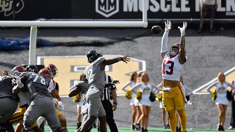 Sep 30, 2023; Boulder, Colorado, USA; Colorado Buffaloes quarterback Shedeur Sanders (2) gets his pass knocked down by USC Trojans linebacker Mason Cobb (13) during the first quarter at Folsom Field. Mandatory Credit: John Leyba-USA TODAY Sports