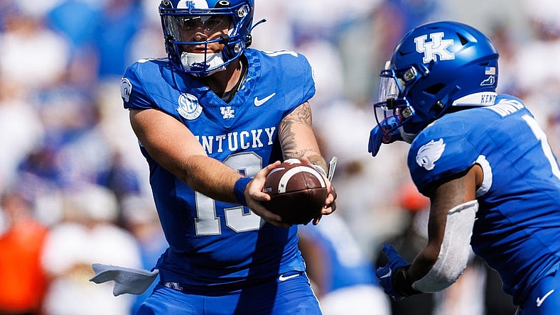 Sep 30, 2023; Lexington, Kentucky, USA; Kentucky Wildcats quarterback Devin Leary (13) hands the ball to running back Ray Davis (1) during the second quarter against the Florida Gators at Kroger Field. Mandatory Credit: Jordan Prather-USA TODAY Sports