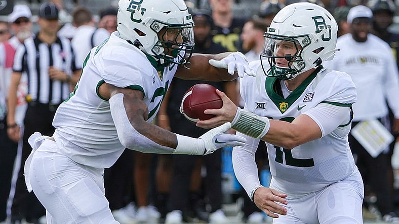 Sep 30, 2023; Orlando, Florida, USA; Baylor Bears quarterback Blake Shapen (12) hands off to running back Dominic Richardson (21) during the first quarter against the UCF Knights at FBC Mortgage Stadium. Mandatory Credit: Mike Watters-USA TODAY Sports