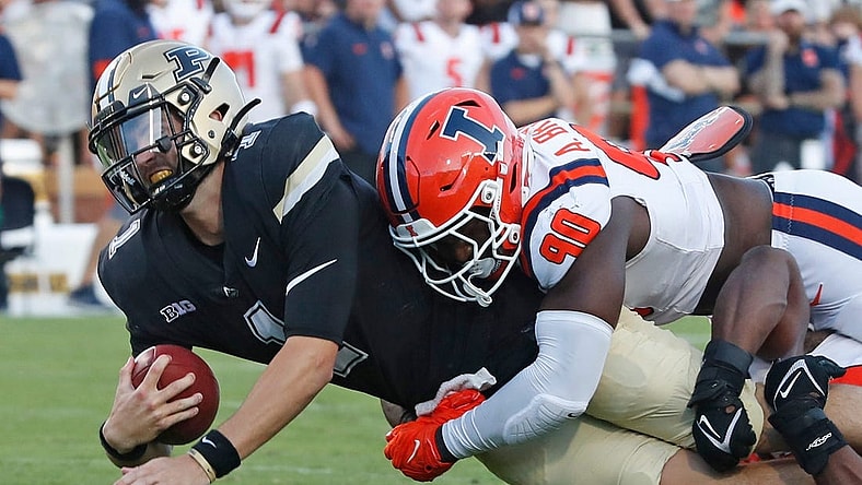 Purdue Boilermakers quarterback Hudson Card (1) is tackled by Illinois Fighting Illini linebacker Alec Bryant (90) during the NCAA football game, Saturday, Sept. 30, 2023, at Ross-Ade Stadium in West Lafayette, Ind. Purdue Boilermakers won 44-19.