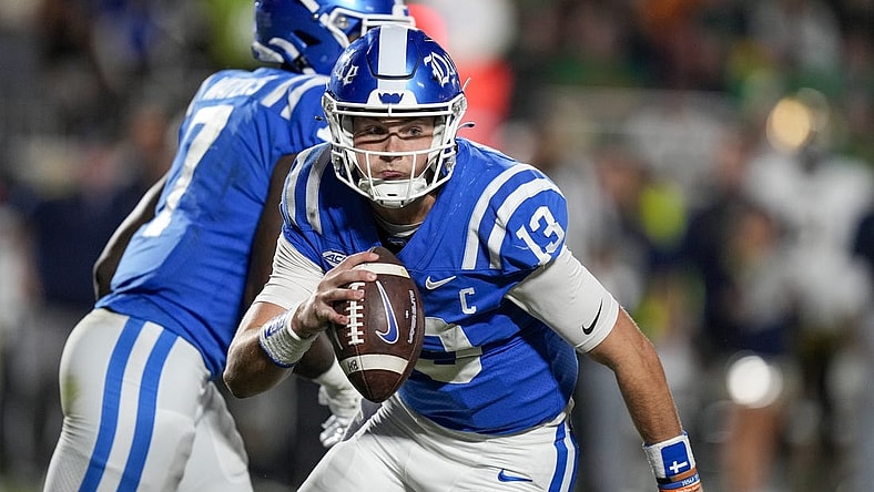 Sep 30, 2023; Durham, North Carolina, USA; Duke Blue Devils quarterback Riley Leonard (13) is forced to run during the second quarter against the Notre Dame Fighting Irish at Wallace Wade Stadium. Mandatory Credit: Jim Dedmon-USA TODAY Sports