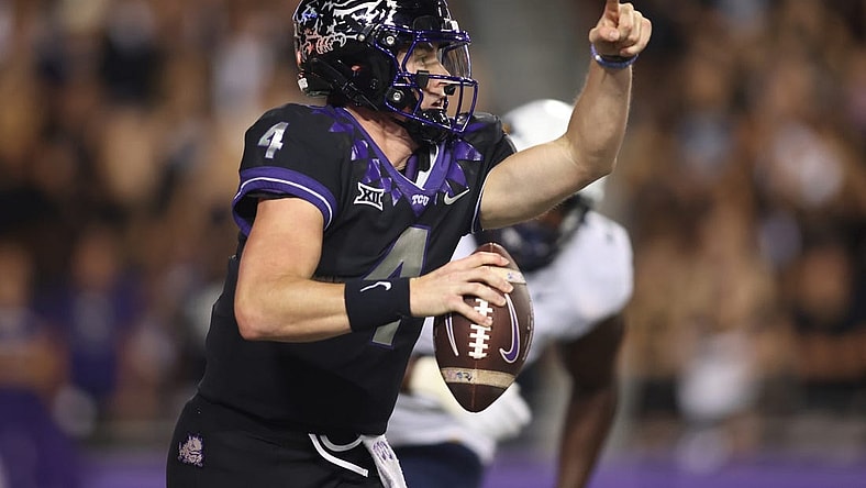 Sep 30, 2023; Fort Worth, Texas, USA; TCU Horned Frogs quarterback Chandler Morris (4) rolls out to pass against West Virginia Mountaineers defensive lineman Tomiwa Durojaiye (3) in the second quarter at Amon G. Carter Stadium. Mandatory Credit: Tim Heitman-USA TODAY Sports