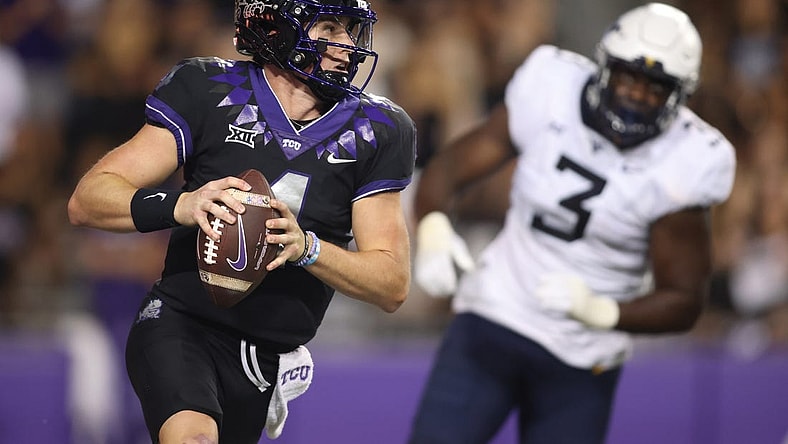 Sep 30, 2023; Fort Worth, Texas, USA; TCU Horned Frogs quarterback Chandler Morris (4) rolls out to pass against West Virginia Mountaineers defensive lineman Tomiwa Durojaiye (3) in the second quarter at Amon G. Carter Stadium. Mandatory Credit: Tim Heitman-USA TODAY Sports