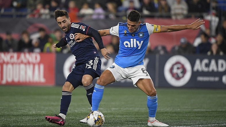 Sep 30, 2023; Foxborough, Massachusetts, USA;  New England Revolution midfielder Nacho Gil (23) and Charlotte FC midfielder Ashley Westwood (8) battle for the ball during the first half at Gillette Stadium. Mandatory Credit: Bob DeChiara-USA TODAY Sports