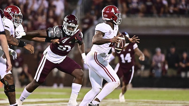 Sep 30, 2023; Starkville, Mississippi, USA; Alabama Crimson Tide quarterback Jalen Milroe (4) moves in the pocket while defended by Mississippi State Bulldogs defensive end Deonte Anderson (91) during the second quarter at Davis Wade Stadium at Scott Field. Mandatory Credit: Matt Bush-USA TODAY Sports