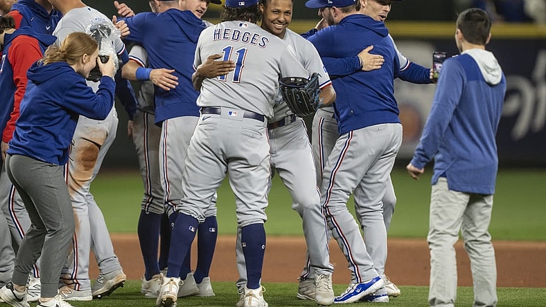 Sep 30, 2023; Seattle, Washington, USA; Texas Rangers relief pitcher Jose Leclerc (25), fourth from right, hugs catcher Austin Hedges (11) after a game against the Seattle Mariners at T-Mobile Park. Mandatory Credit: Stephen Brashear-USA TODAY Sports