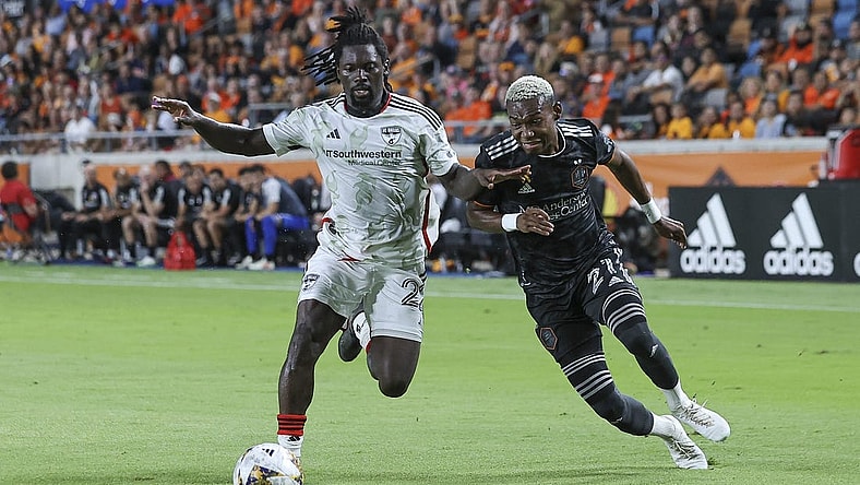 Sep 30, 2023; Houston, Texas, USA; FC Dallas midfielder Ema Twumasi (22) and Houston Dynamo FC forward Nelson Quinones (21) battle for the ball during the second half at Shell Energy Stadium. Mandatory Credit: Troy Taormina-USA TODAY Sports
