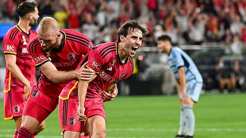 Sep 30, 2023; St. Louis, Missouri, USA; St. Louis City midfielder Jared Stroud (8) celebrates with forward Joao Klauss (9)scoring a goal against Sporting Kansas City during the second half at CITYPARK. Mandatory Credit: Joe Puetz-USA TODAY Sports