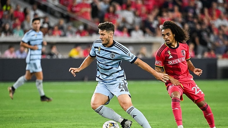 Sep 30, 2023; St. Louis, Missouri, USA; Sporting Kansas City midfielder Nemanja Radoja (6) shields the ball from St. Louis City midfielder Aziel Jackson (25) during the second half at CITYPARK. Mandatory Credit: Joe Puetz-USA TODAY Sports