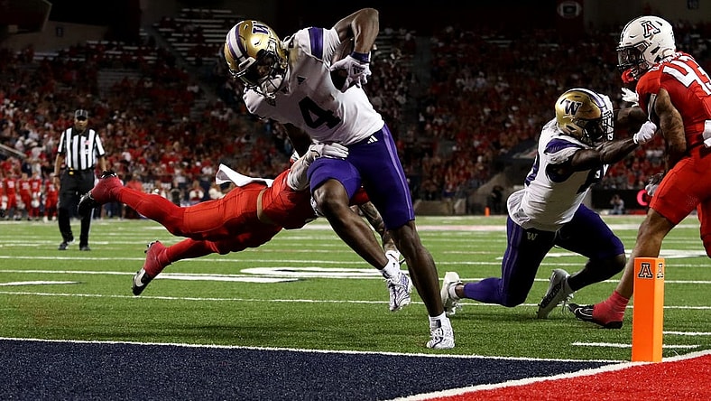 Sep 30, 2023; Tucson, Arizona, USA; Washington Huskies wide receiver Germie Bernard (4) scores a touchdown in the first half at Arizona Stadium. Mandatory Credit: Zachary BonDurant-USA TODAY Sports