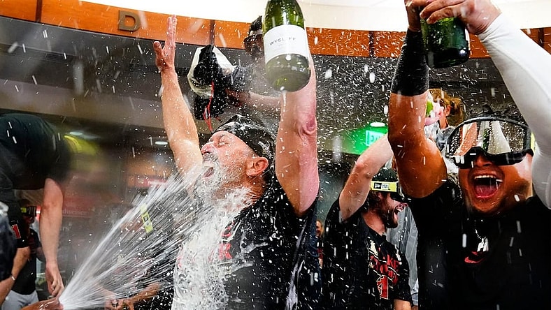 Sep 30, 2023; Phoenix, AZ, USA; Arizona Diamondbacks manager Torey Lovullo is sprayed with champagne during celebrations after clinching a wild card playoff spot following their game with the Houston Astros at Chase Field. Mandatory Credit: Rob Schumacher-Arizona Republic