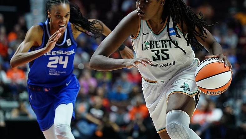 Oct 1, 2023; Uncasville, Connecticut, USA; New York Liberty forward Jonquel Jones (35) drives the ball against Connecticut Sun forward DeWanna Bonner (24) in the first half during game four of the 2023 WNBA Playoffs at Mohegan Sun Arena. Mandatory Credit: David Butler II-USA TODAY Sports