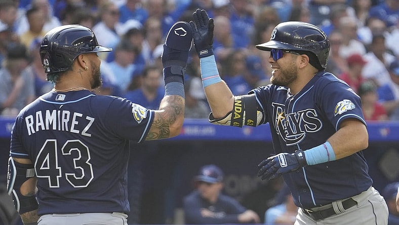 Oct 1, 2023; Toronto, Ontario, CAN; Tampa Bay Rays designated hitter Harold Ramirez (43) congratulates first baseman Jonathan Aranda (62) after his grandslam home run against the Toronto Blue Jays during the second inning at Rogers Centre. Mandatory Credit: John E. Sokolowski-USA TODAY Sports